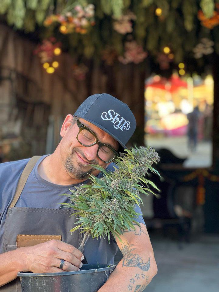 Chef Chris Cosentino holding cannabis at Sonoma Hills Farm